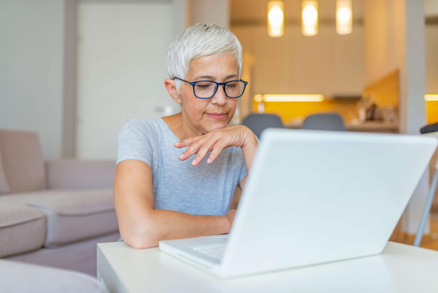 Woman,Wearing,Glasses,At,Home,Concentrating,As,She,Works,On